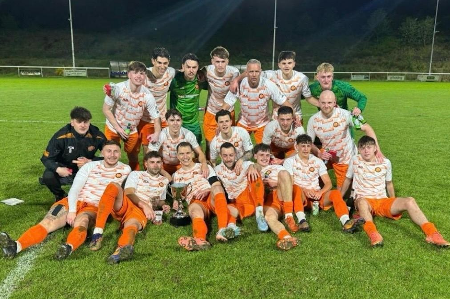 Pure Swansea Captain Jordan Hughes with the Ardal Southern West Championship Trophy 2025/26 surrounded by his team.